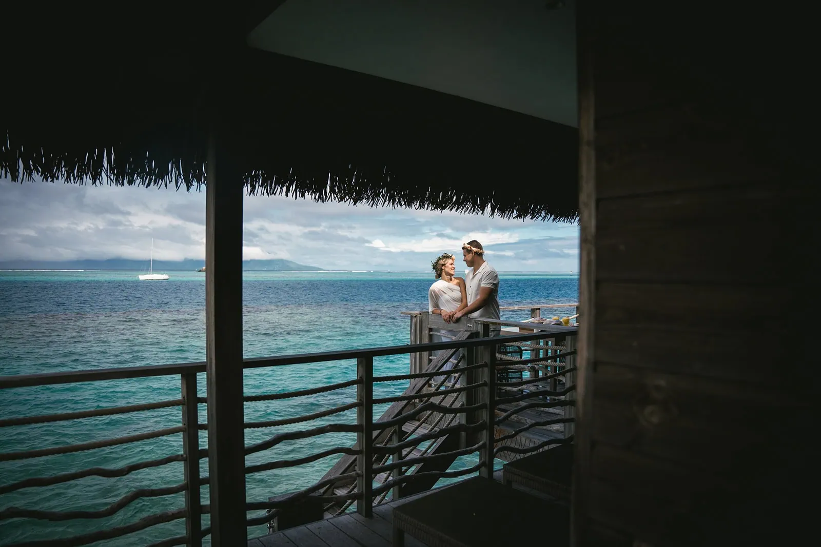 Couple embrace near the Polynesian ocean during their elopement