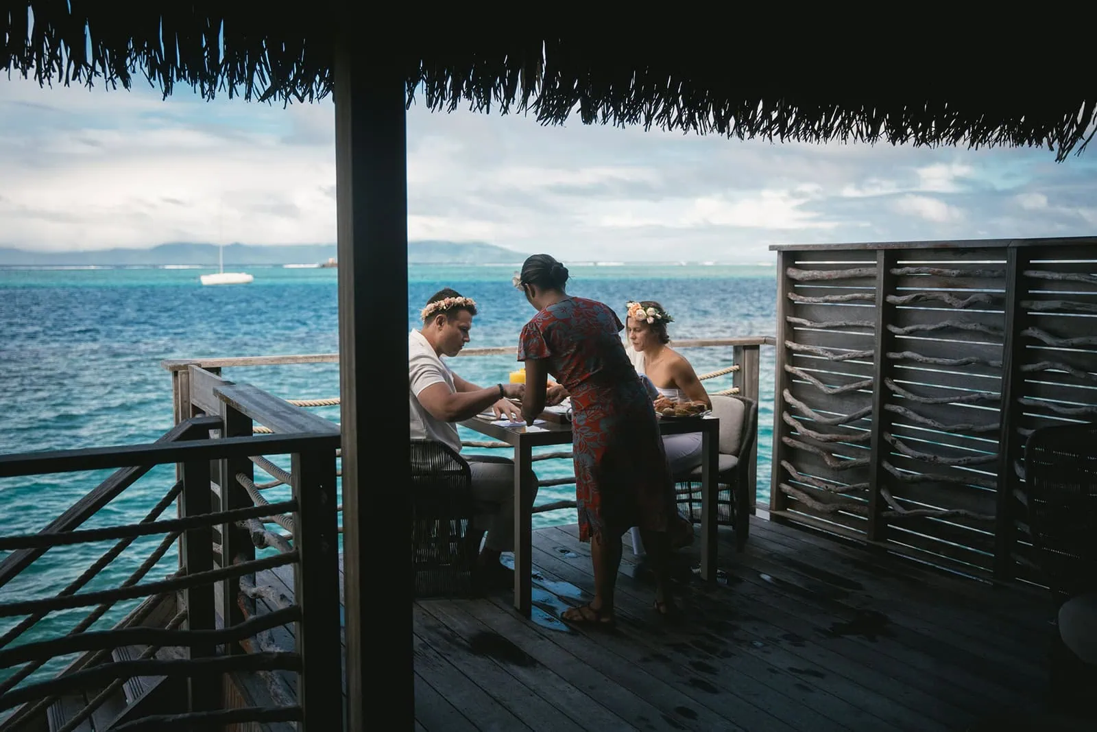 Newlyweds taking part in a traditional Polynesian meal