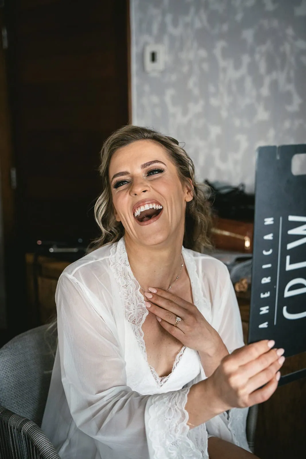 Bride laughing during her set-up for the elopement ceremony