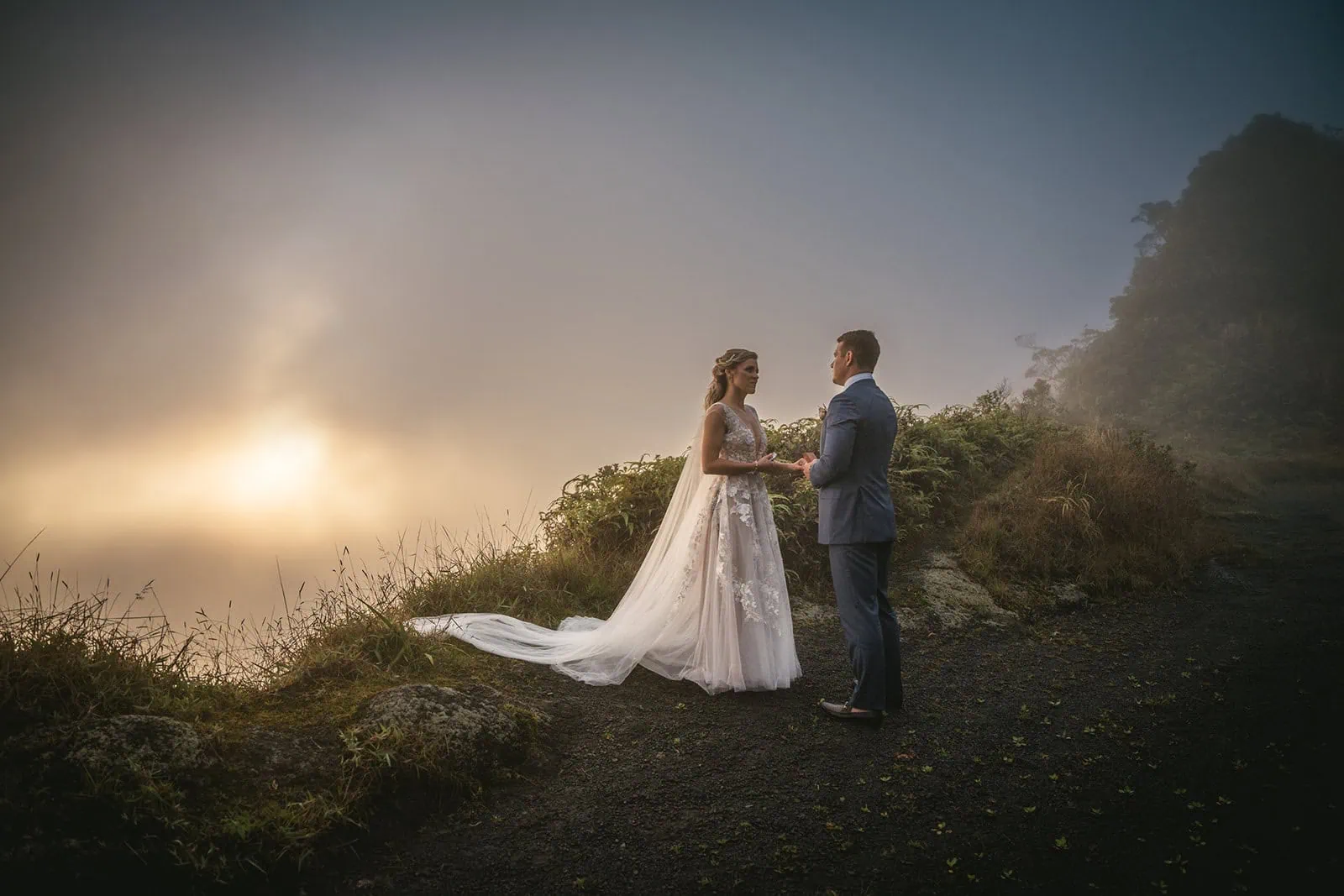 Couple exchanging vows with dramatic mountain views in the background in French Polynesia