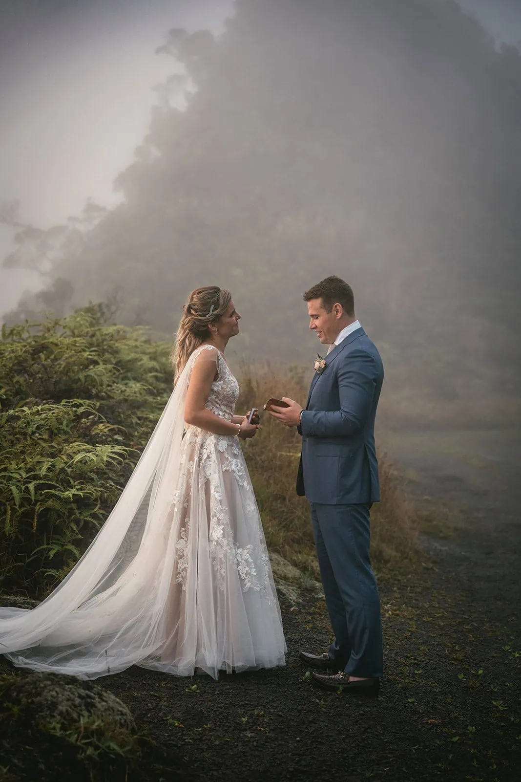 Couple exchanging vows with dramatic mountain views in the background in a French Polynesia elopement