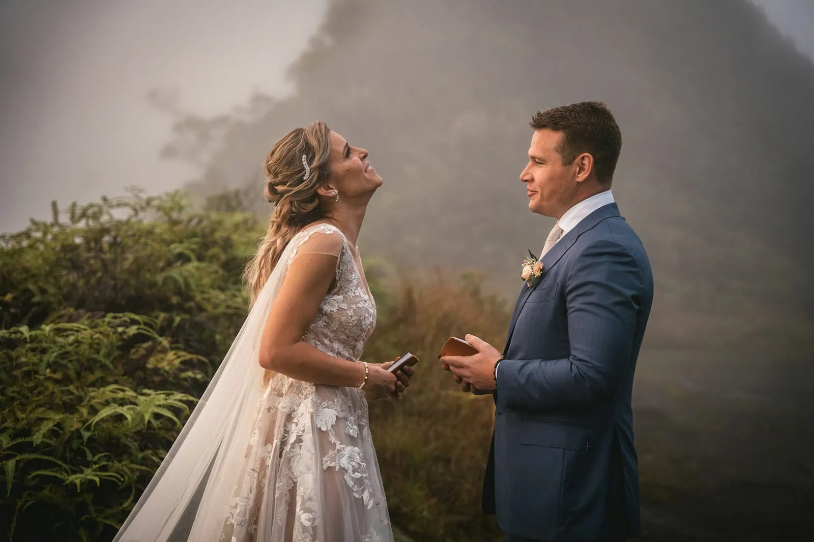 Couple exchanging vows with dramatic mountain views in the background in French Polynesia