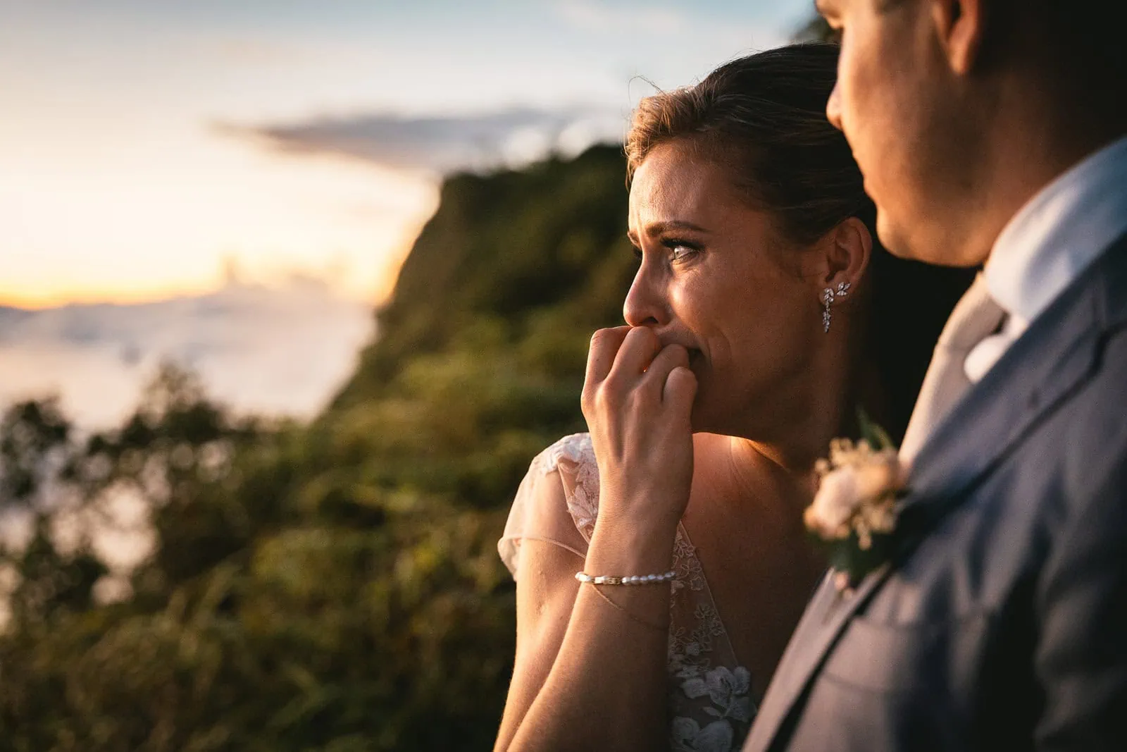 Bride touching by the dramatic view during her elopement ceremony in French Polynesia