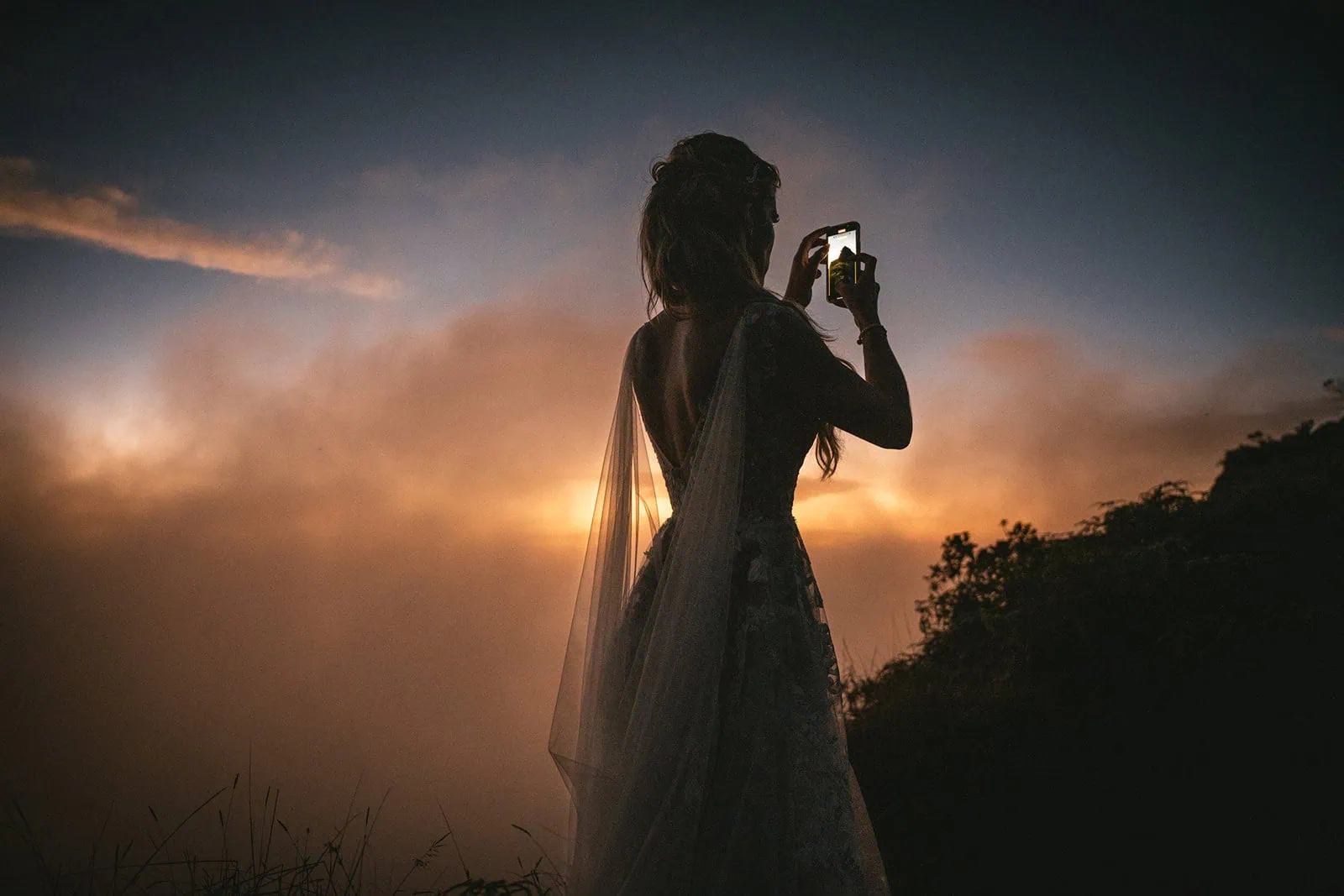 Bride's veil fluttering in the breeze during a beach elopement in French Polynesia