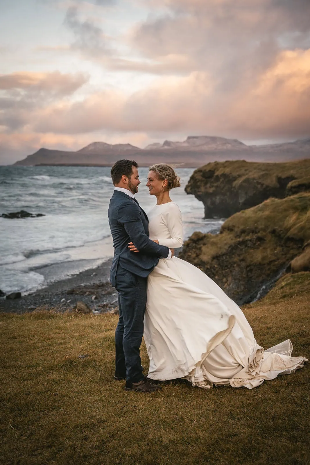 Bride and groom laughing together in Iceland’s landscape