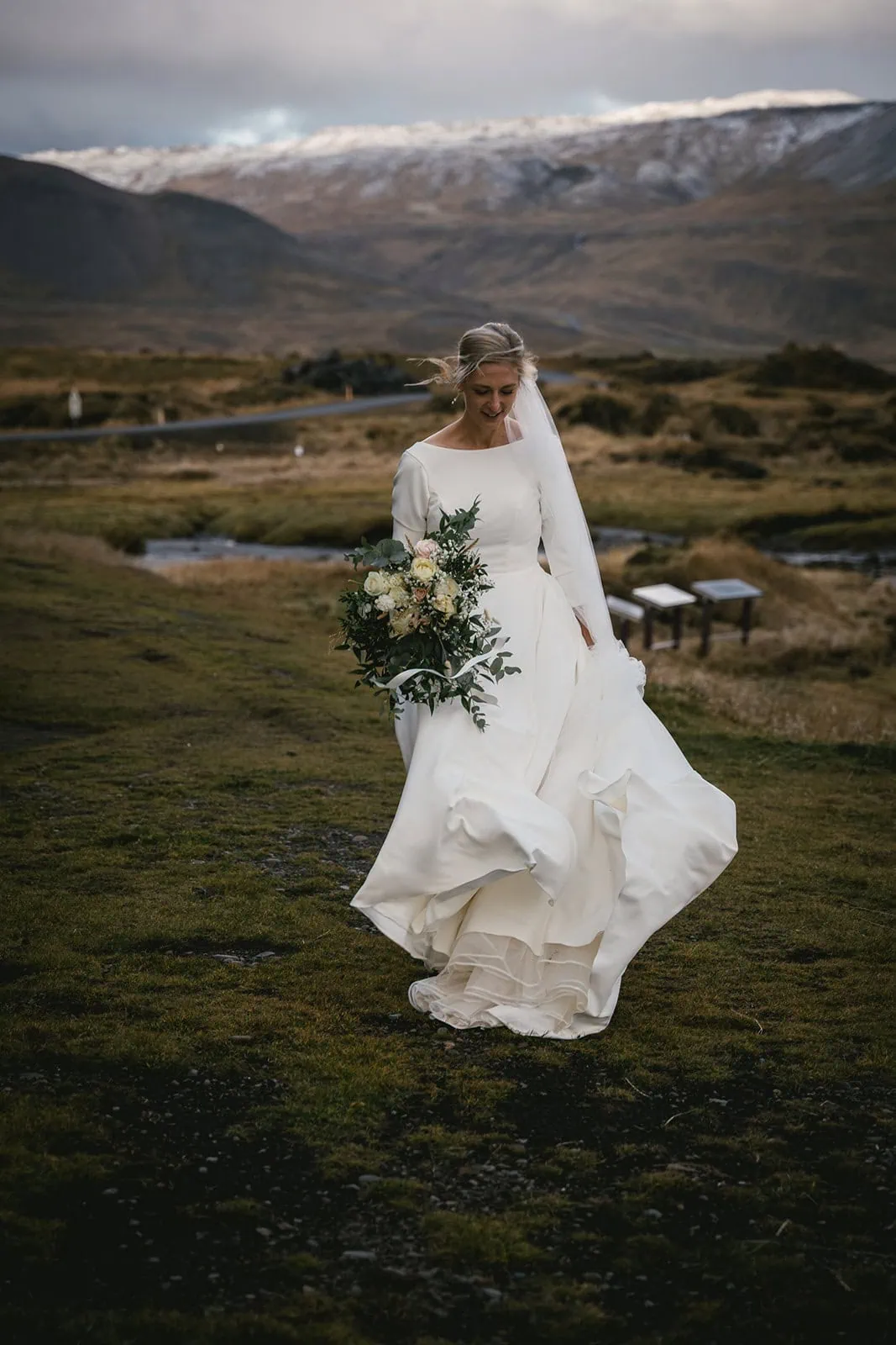 Elopement in Iceland: Bride walking through a scenery landscape