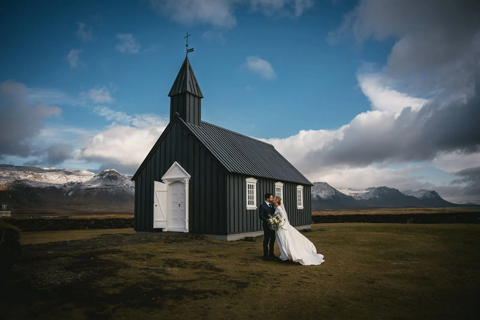 Romantic Iceland elopement: Couple beside a black church