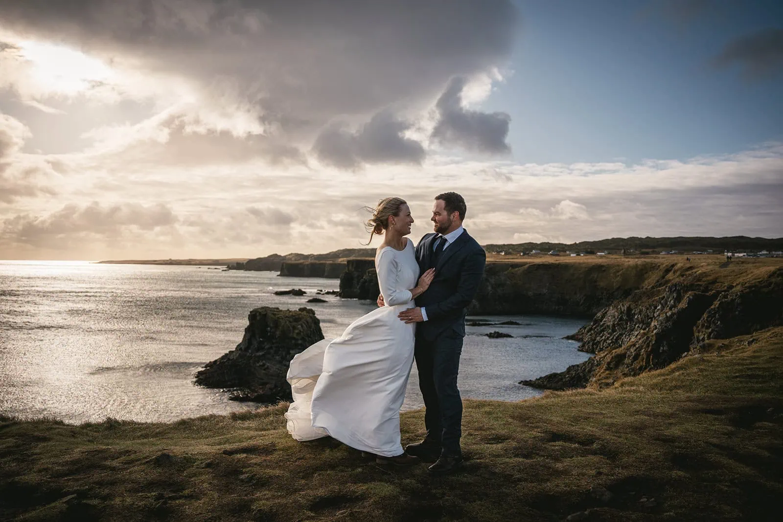 Newlyweds pausing on a scenic cliff during their Iceland elopement