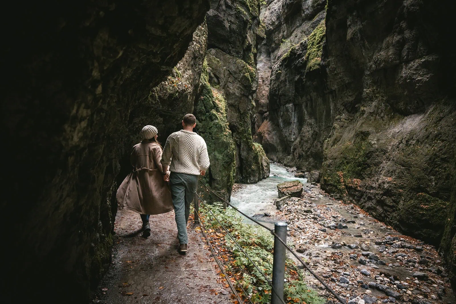 Newlyweds laughing together as they exploring a German cave, adding a sense of adventure to their elopement