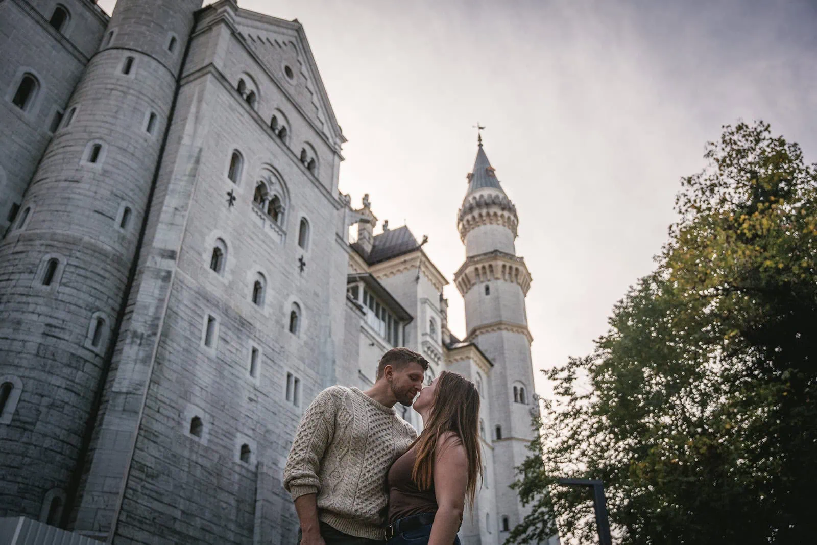 Passionate kiss captured inside the gates of Neuschwanstein Castle, fairytale Germany elopement