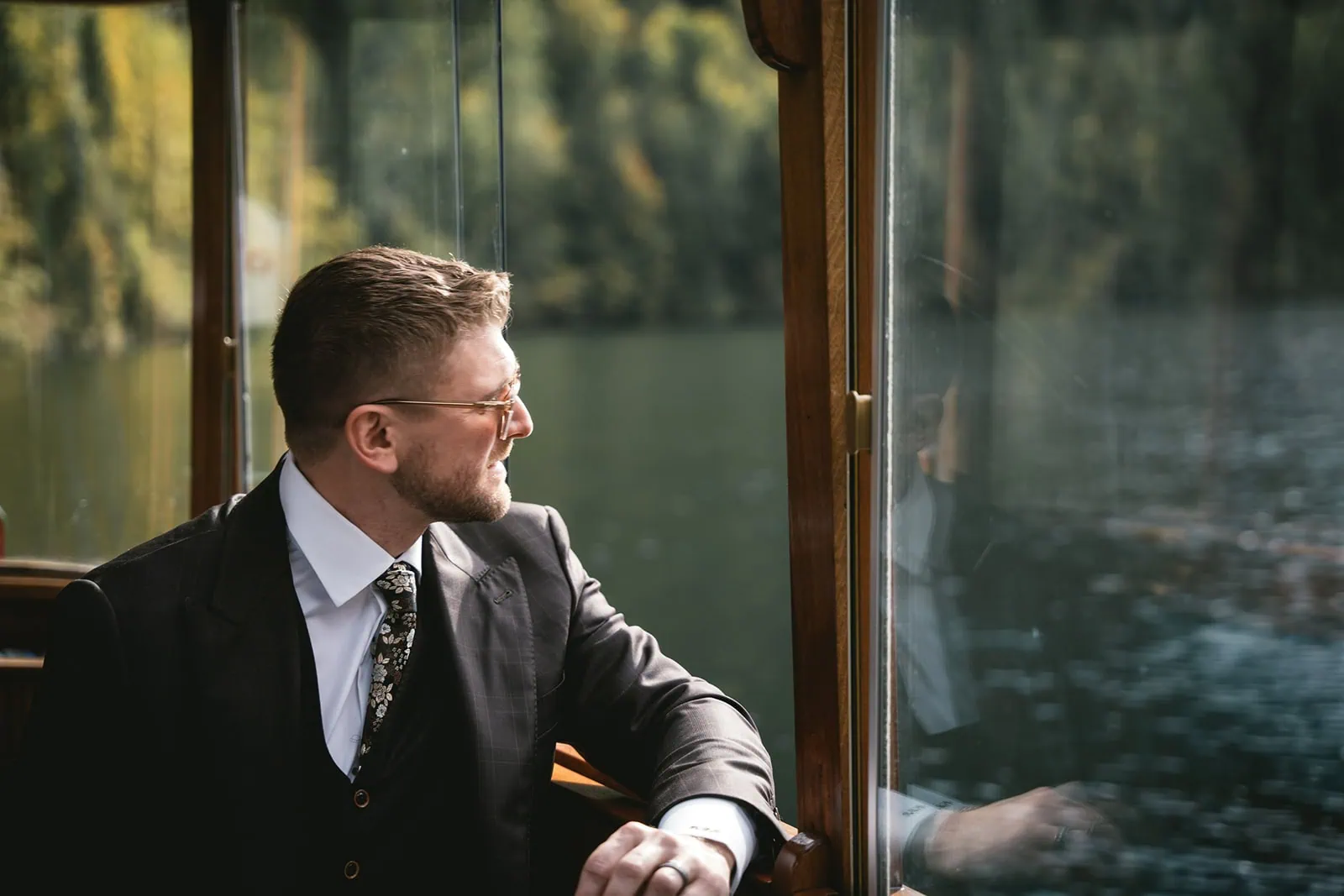 Groom pensively looking out over the mountains before his Austria elopement ceremony