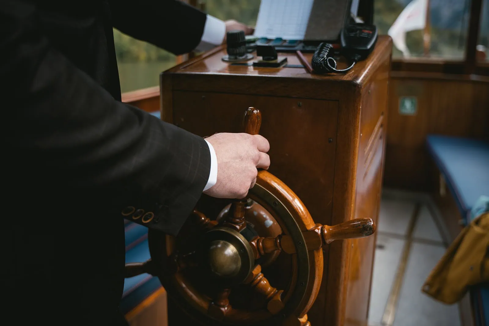 Groom guiding the boat on the Obersee lake in Germany