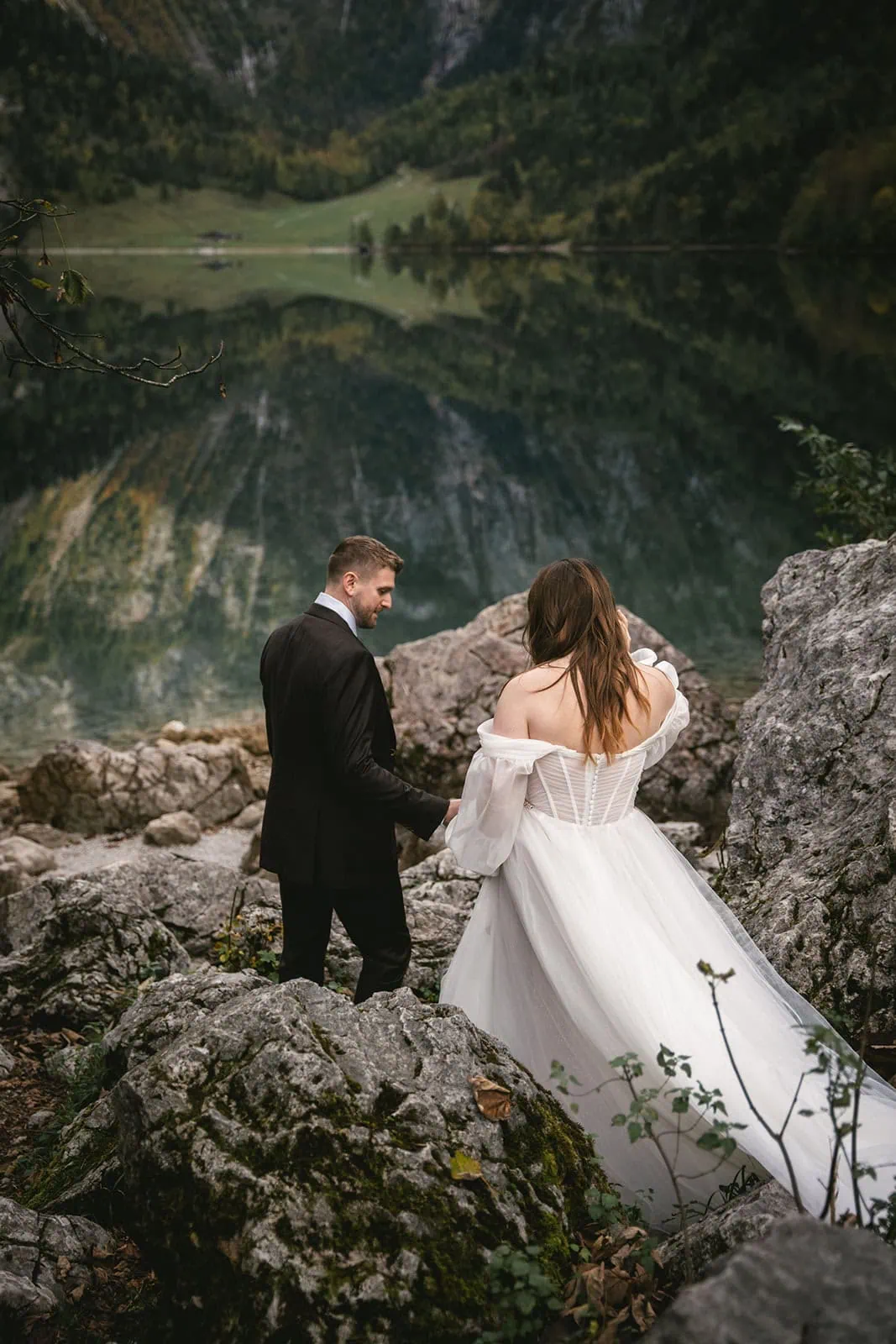 Groom and bride walking near a serene lake, adventurous Germany elopement