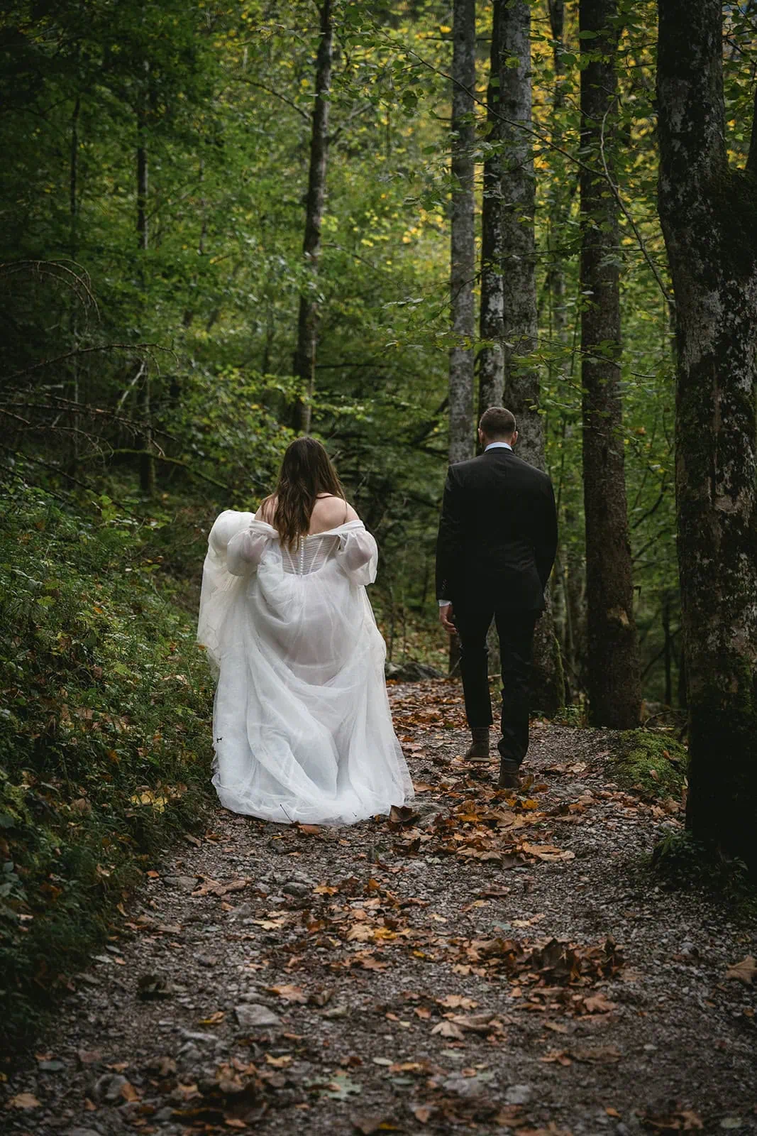 Romantic post-ceremony walk through a forest in Germany, springtime elopement