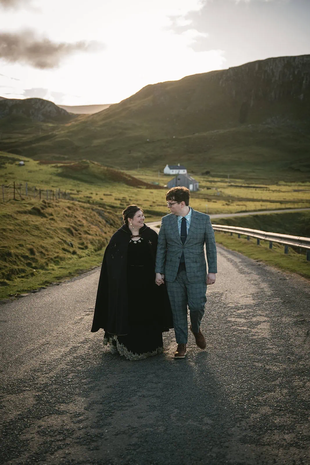 Bride and groom walking through the quaint Skye countryside