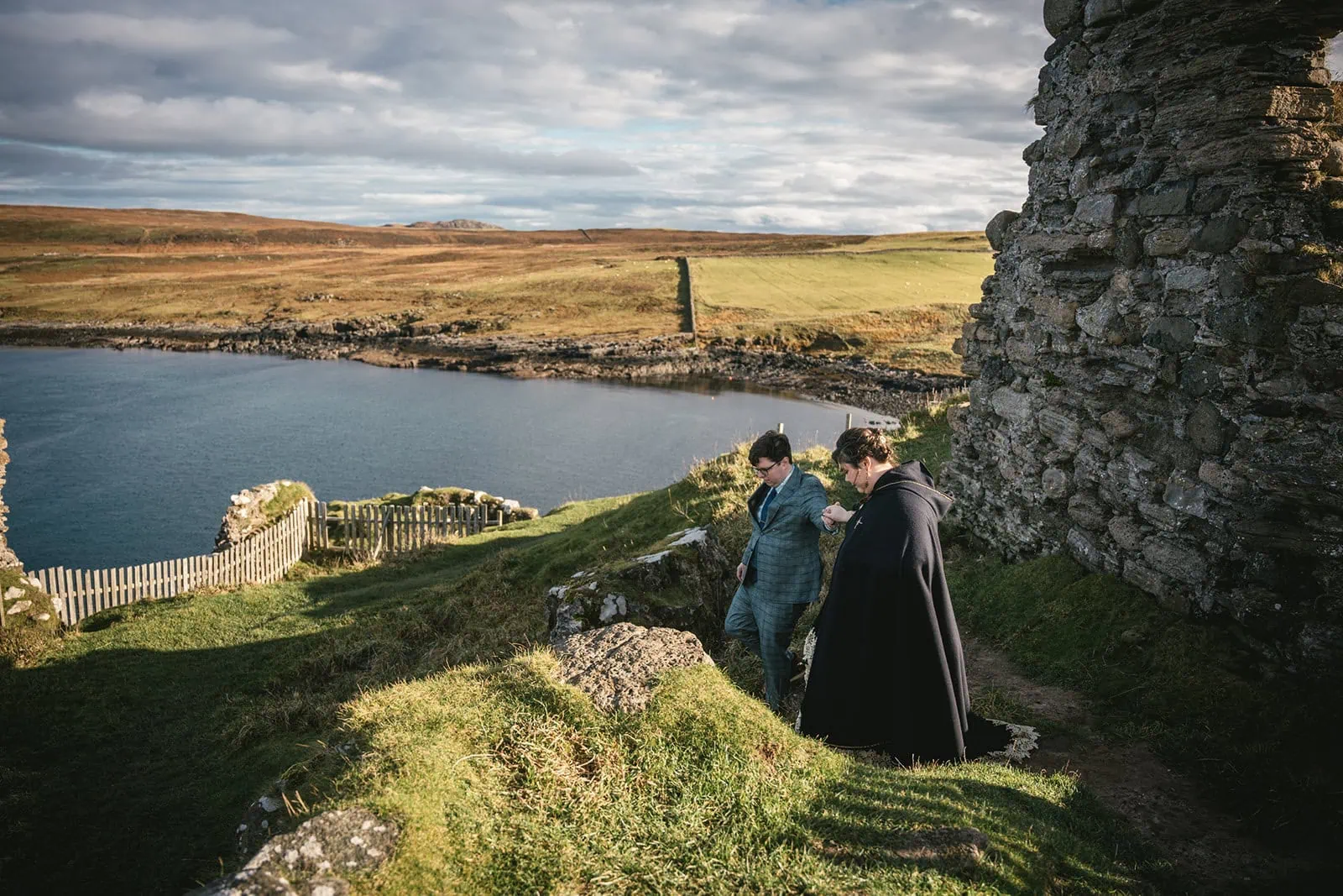 Bride and groom walking in a breathtaking landscape in their Skye elopement