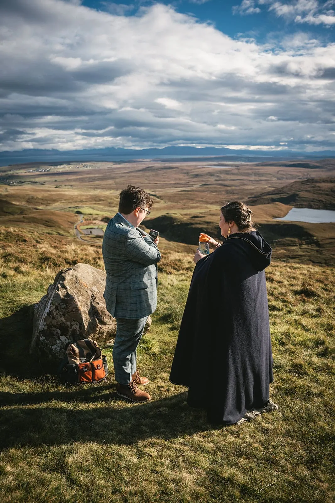 Couple pausing to watch landscape, a serene moment in their Skye elopement