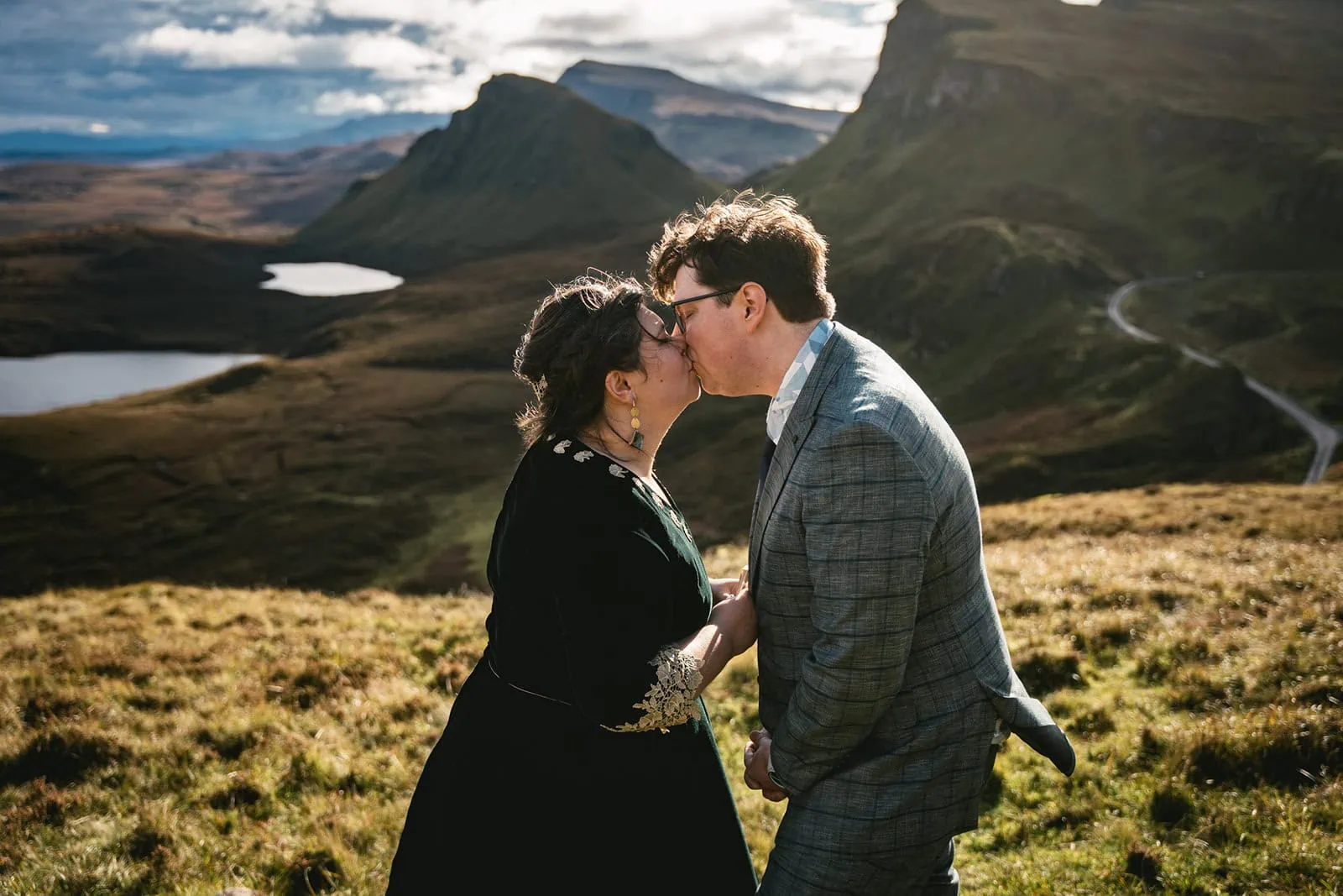 Couple sharing a kiss while exchanging vows during their Skye elopement