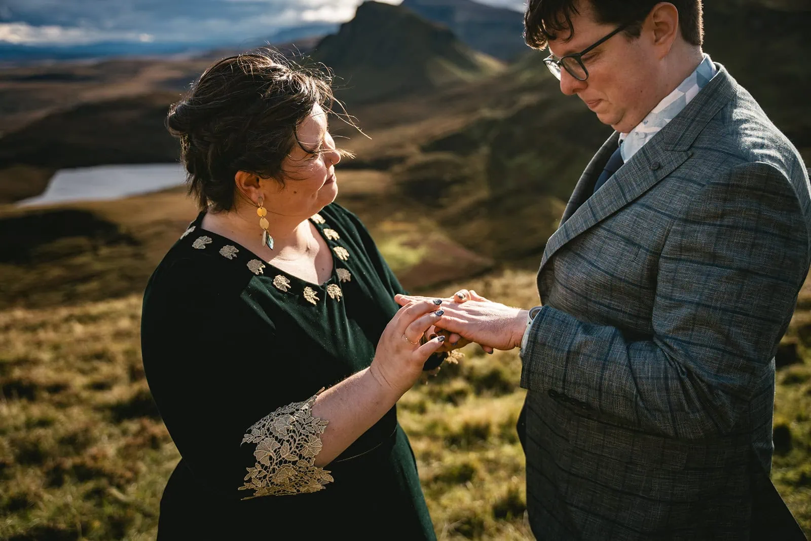 Skye elopement: Bride and groom exchanging rings in a serene background