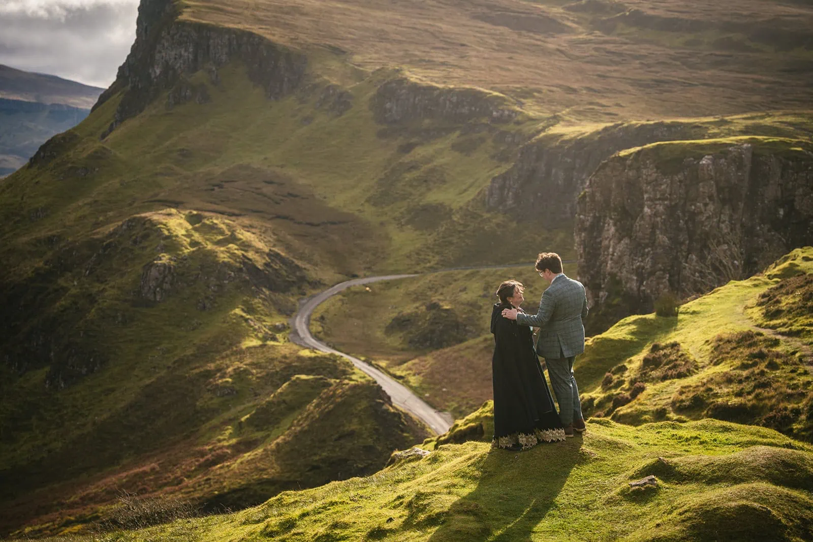 Bride and groom sharing a quiet moment on a secluded cliff on the Isle of Skye