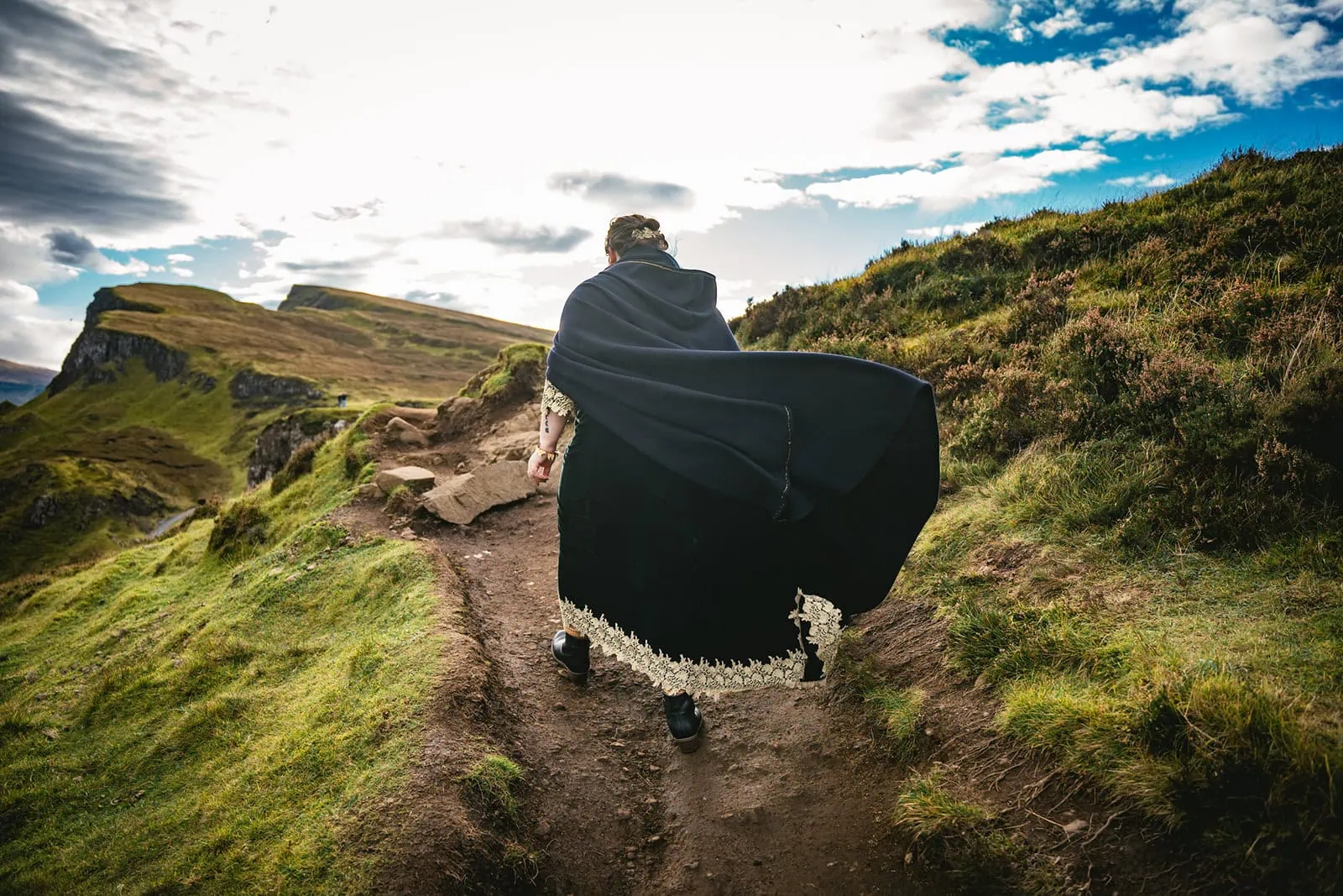 Bride's flowing cape in the Skye wind, during her Scotland elopement