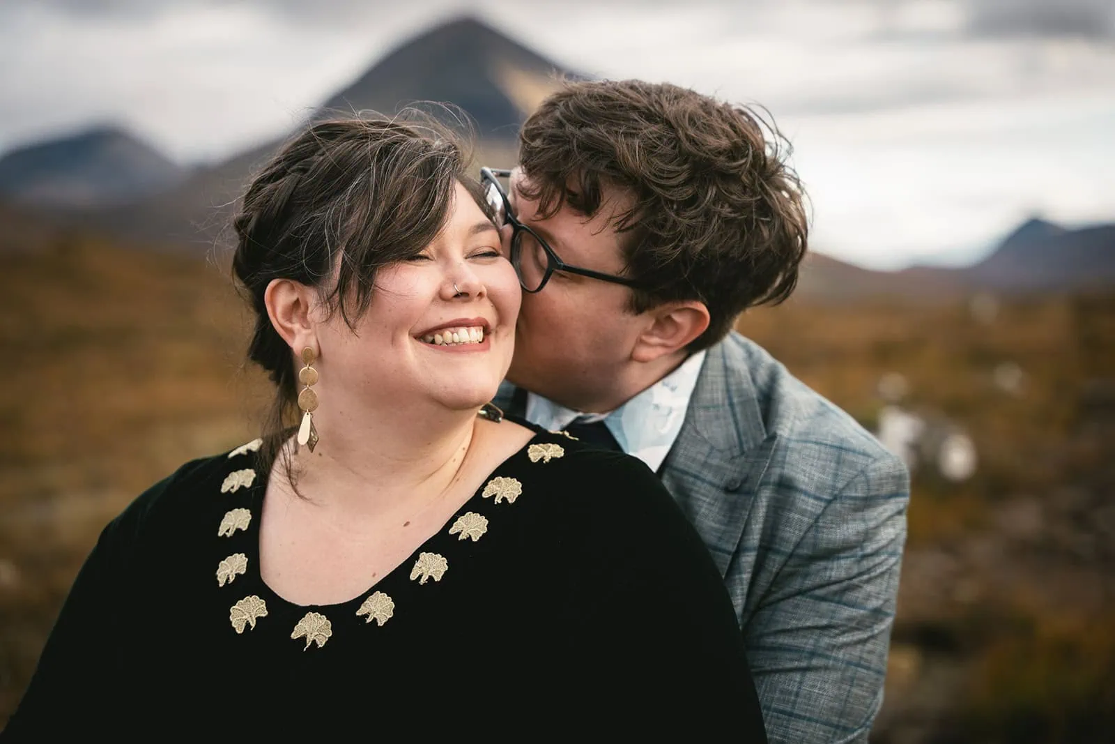 Groom lifting the bride in a joyful embrace on the Isle of Skye