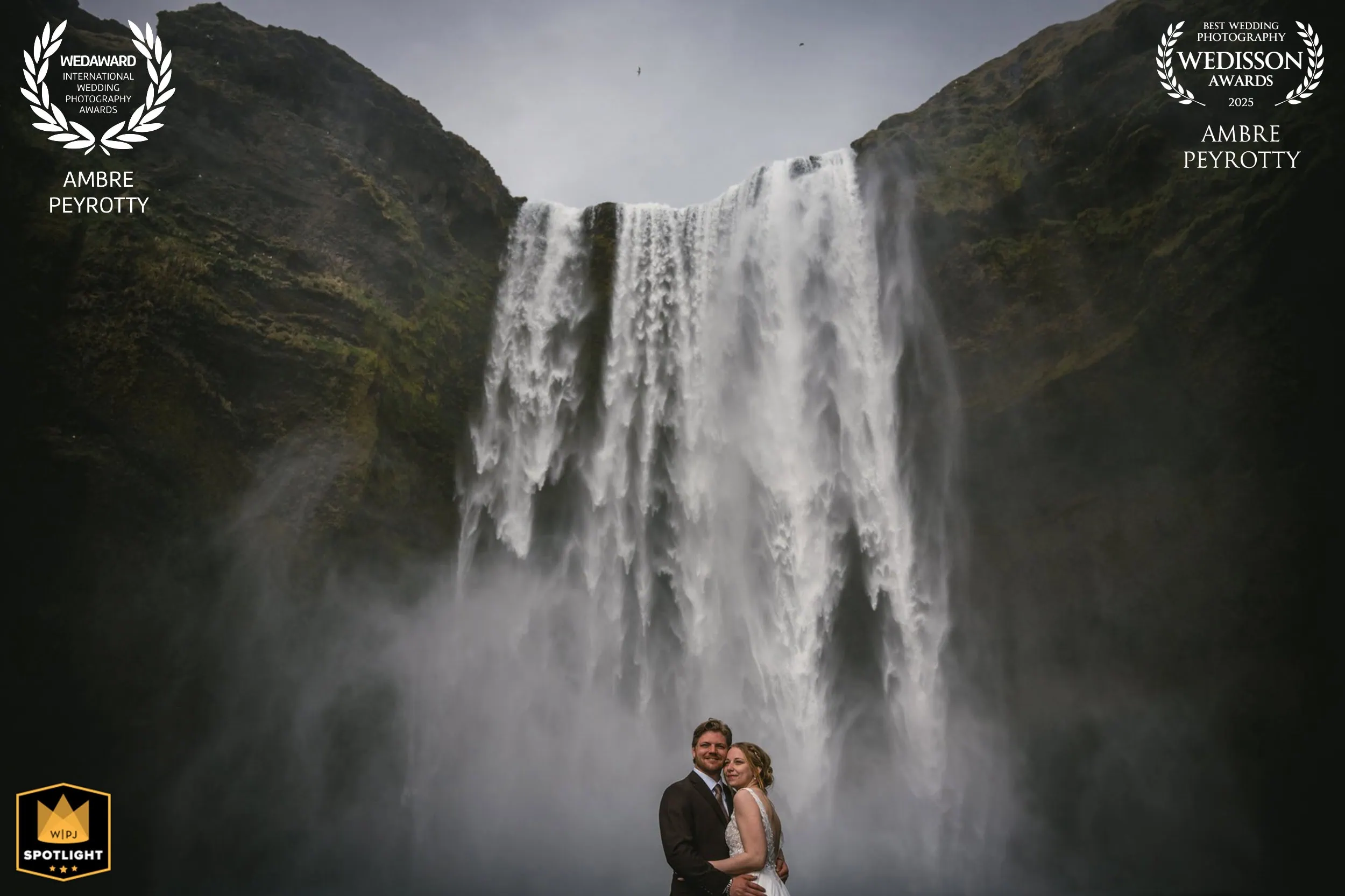 Elopement photo featuring a couple in front of a majestic waterfall in Canada.