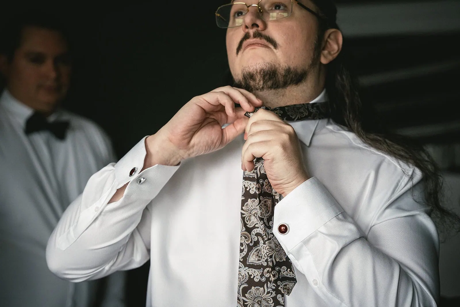 Groom wearing his tie during his Dunluce Castle elopement