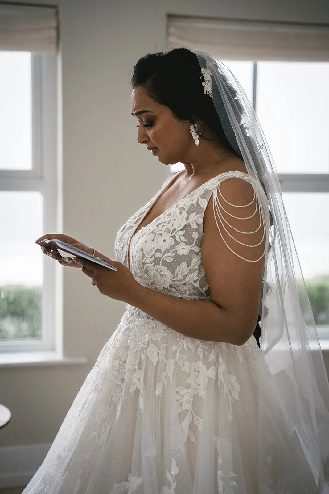 Bride reading her vows at her groom during a Dunluce Castle elopement