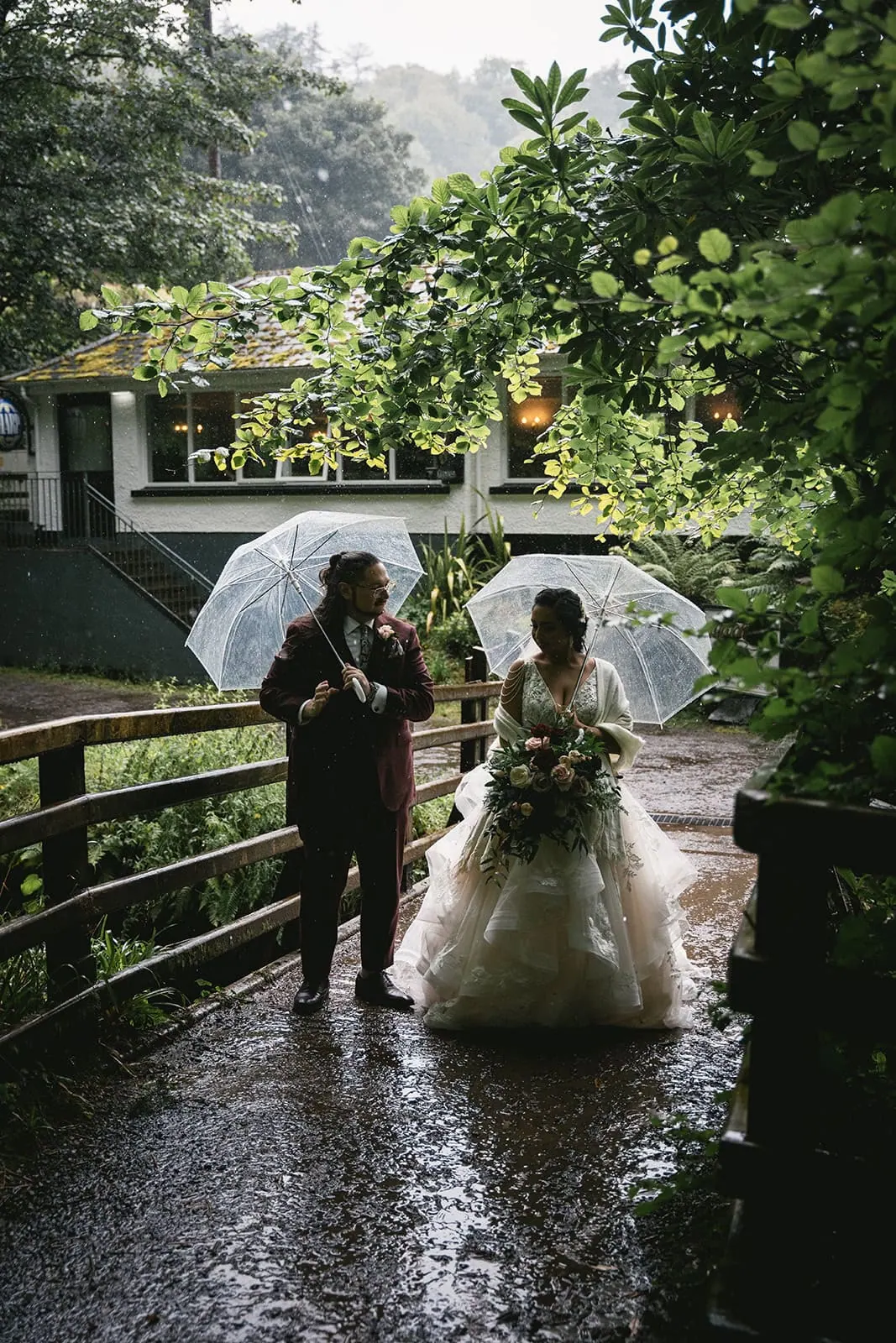 The couple holding umbrellas at Dunluce Castle elopement in the rain