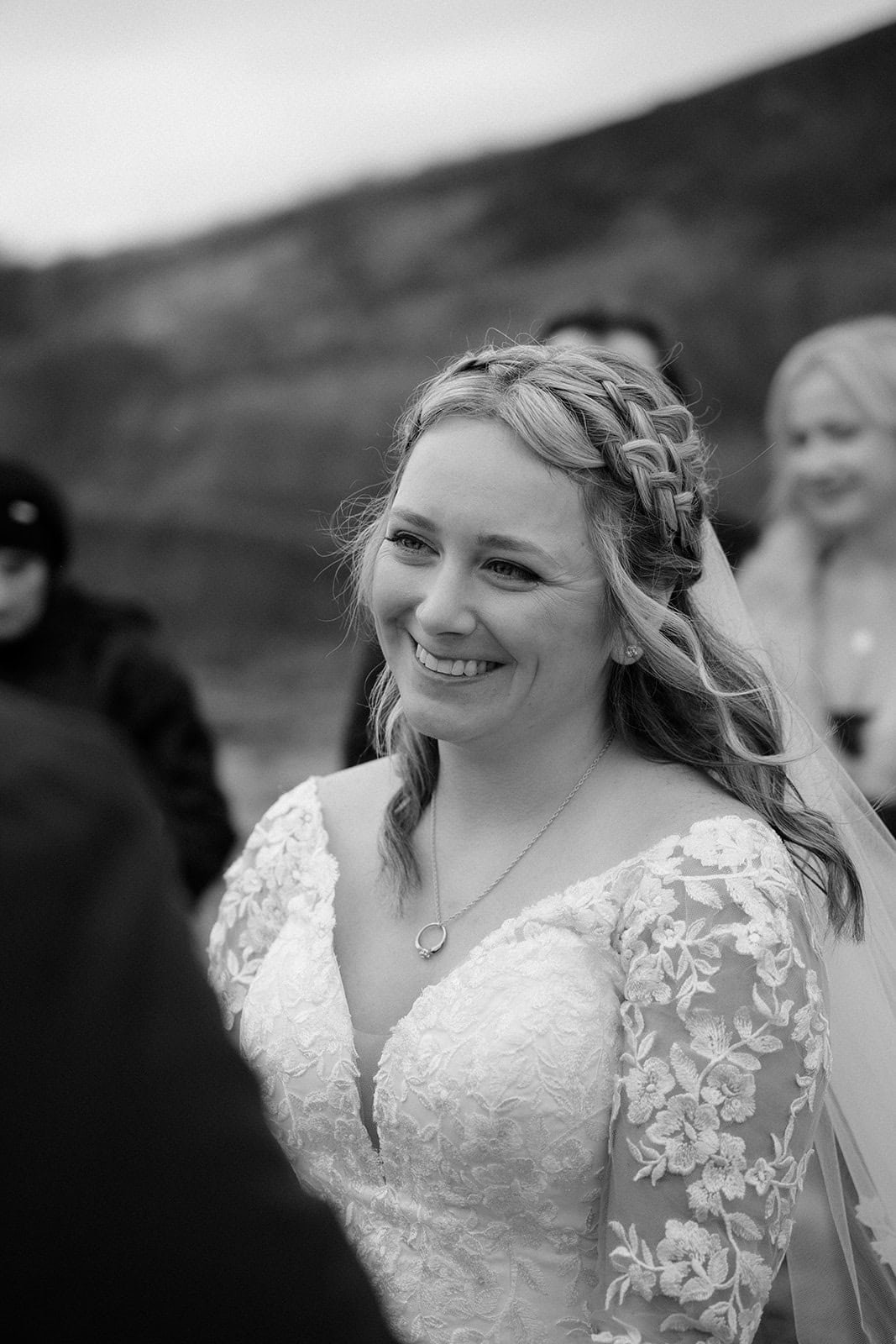 Bride looking at her partner with a waterfall in the background during their Iceland elopement