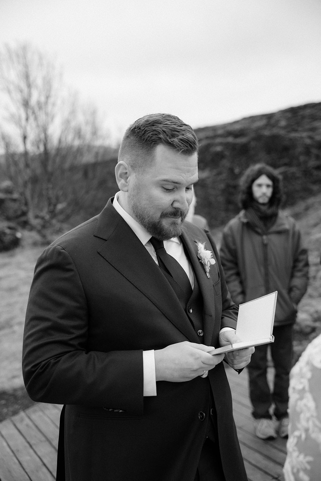 Groom reading his vows during an Iceland waterfall elopement adventure