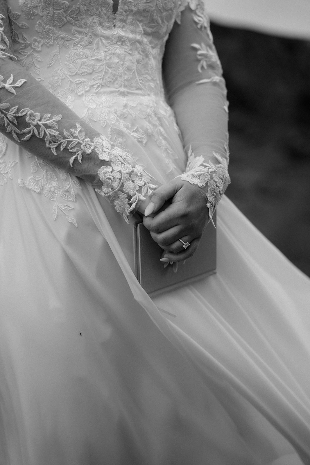 A close-up of the bride's hands holding her vows in her Icelandic waterfall elopement