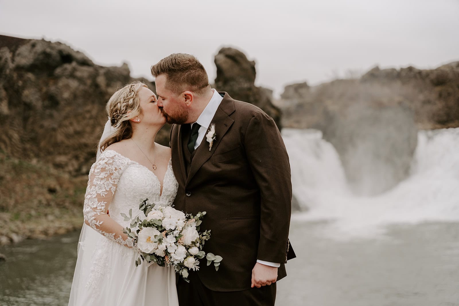 Stunning Icelandic scenery surrounding the couple during their waterfall elopement