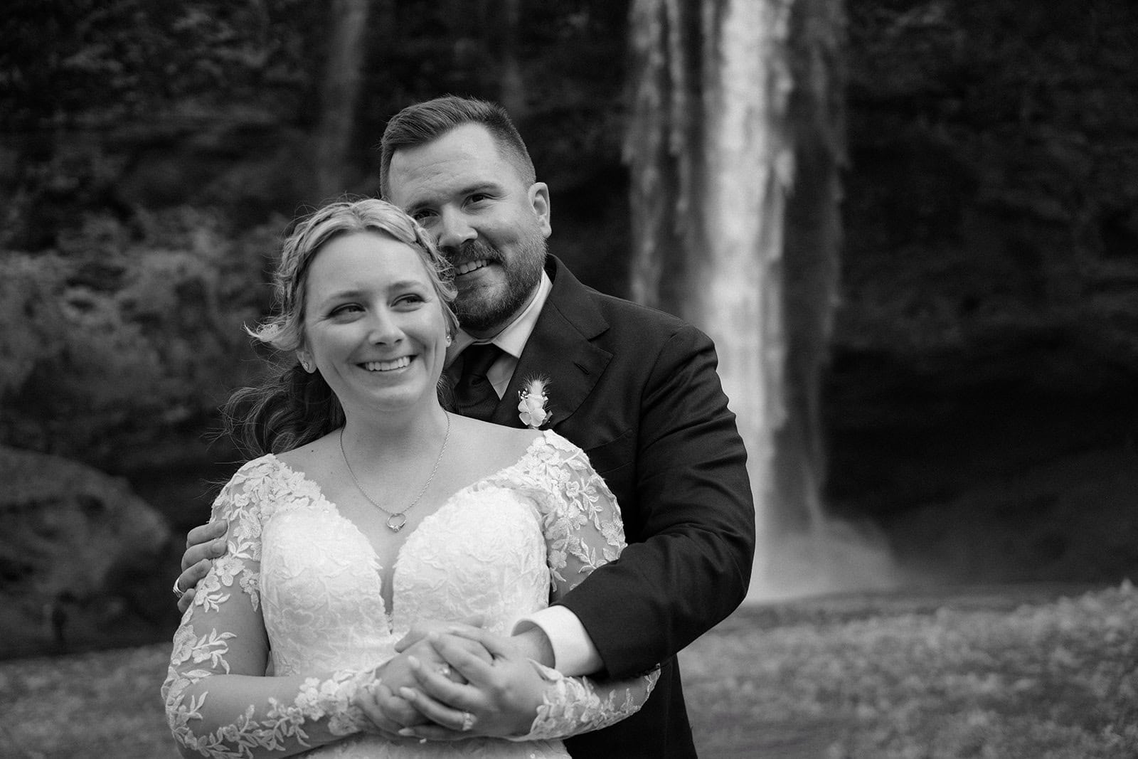 Iceland waterfall elopement with a backdrop of moss-covered rocks and cascading waters