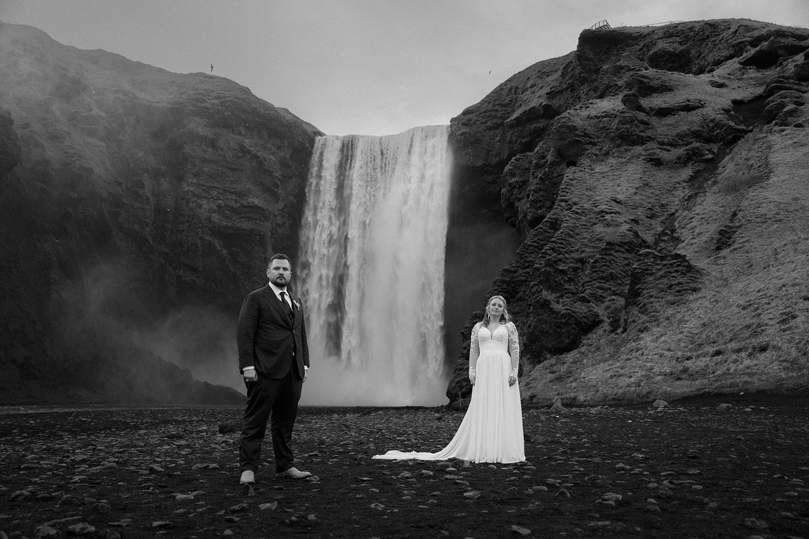 Elopement ceremony framed by Iceland’s rugged terrain and a majestic waterfall