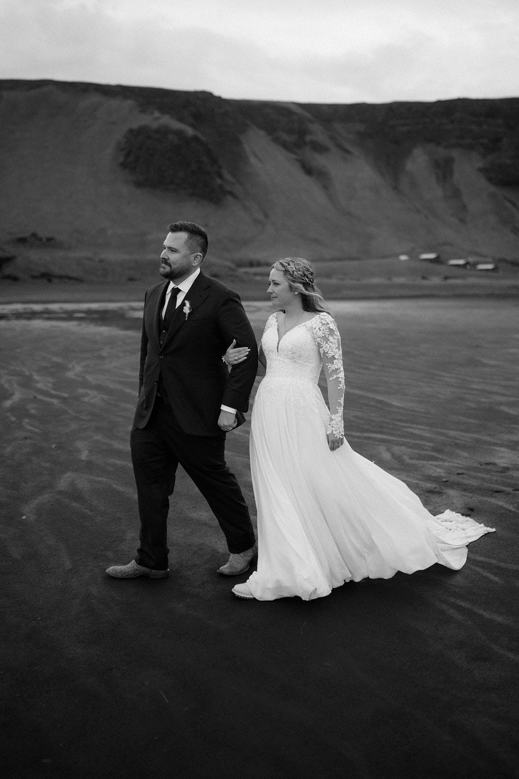 The waterfall in the distance as the couple shares a moment together during the elopement