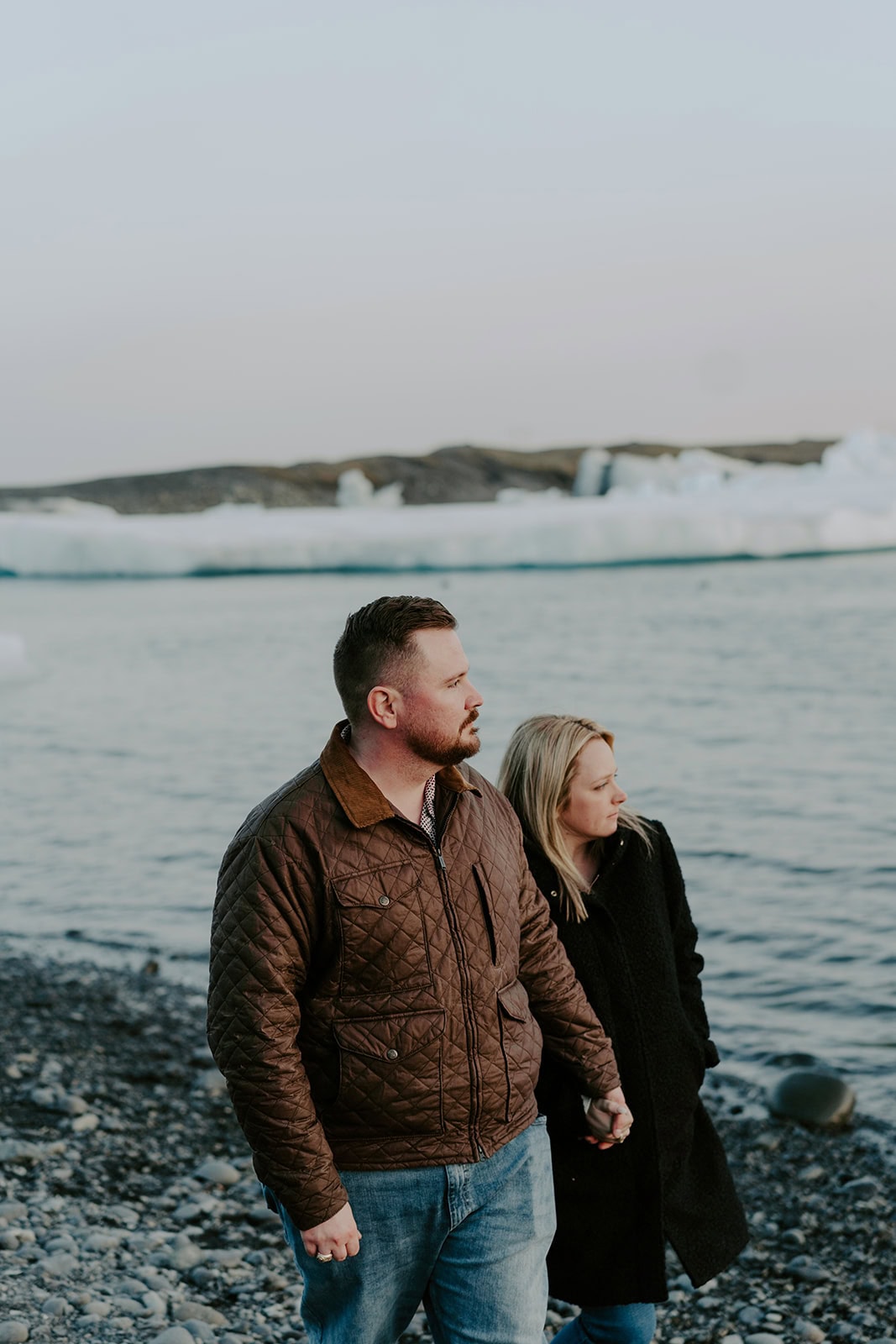 A serene moment by the glacier during an intimate Iceland waterfall elopement