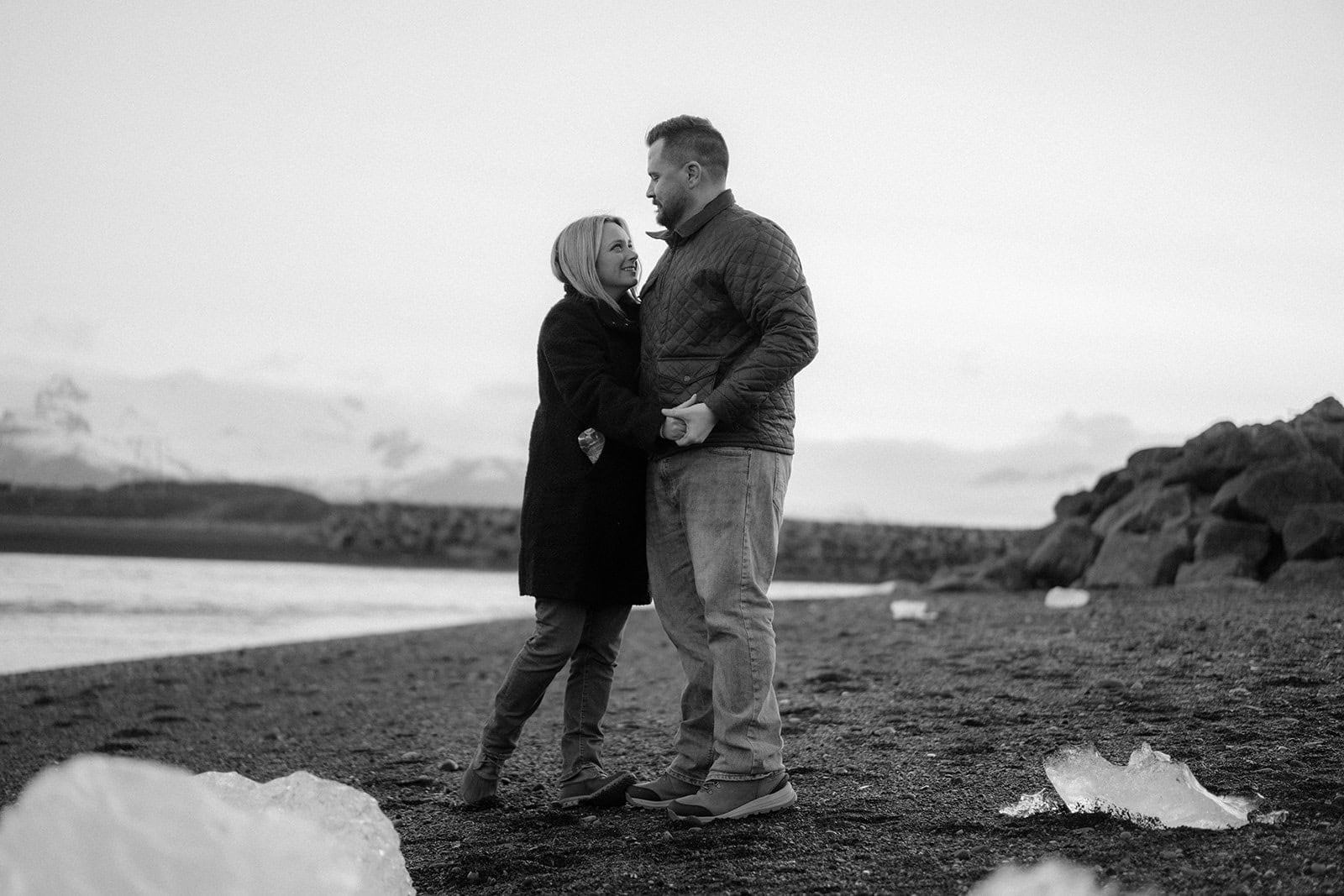 Couple standing on a glacierin their Iceland waterfall elopement