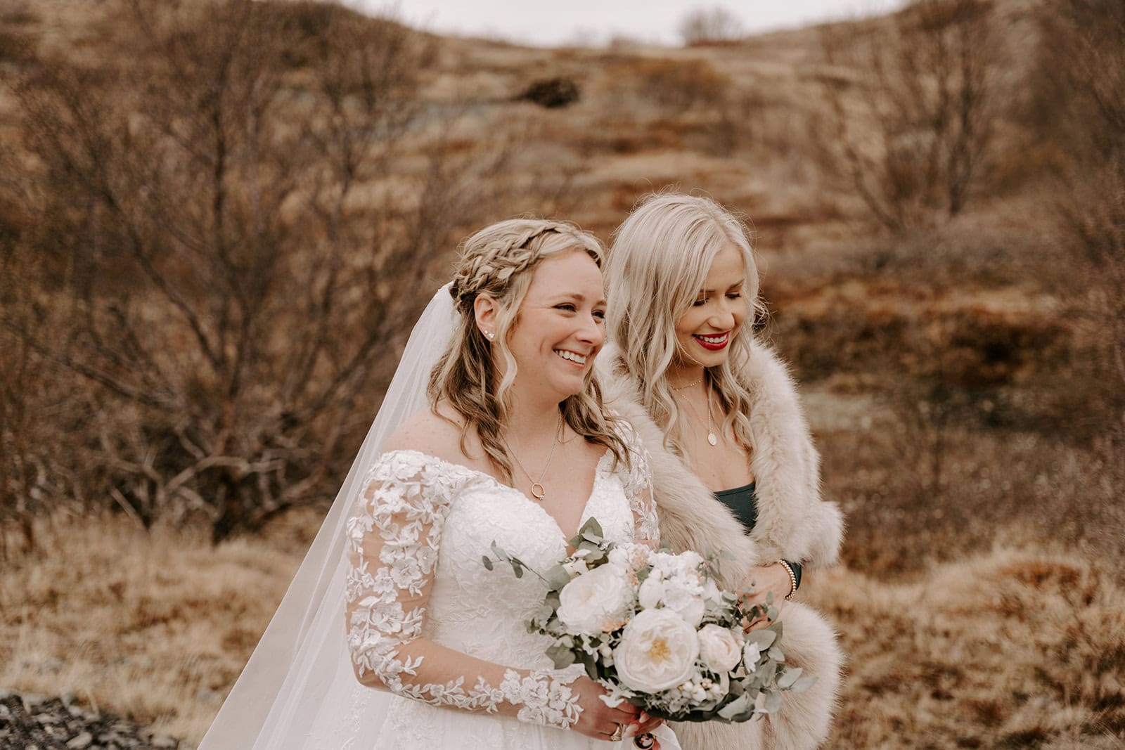 Bride holding her bouquet against the backdrop of an Icelandic waterfall elopement