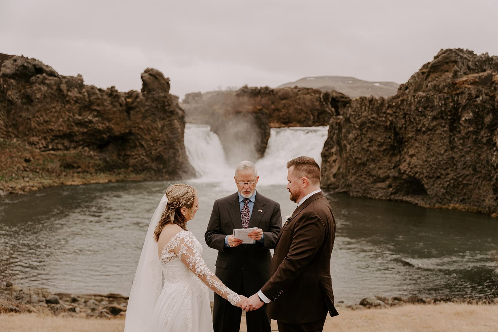 Elopement ceremony by a stunning Icelandic waterfall, capturing the magic of the moment