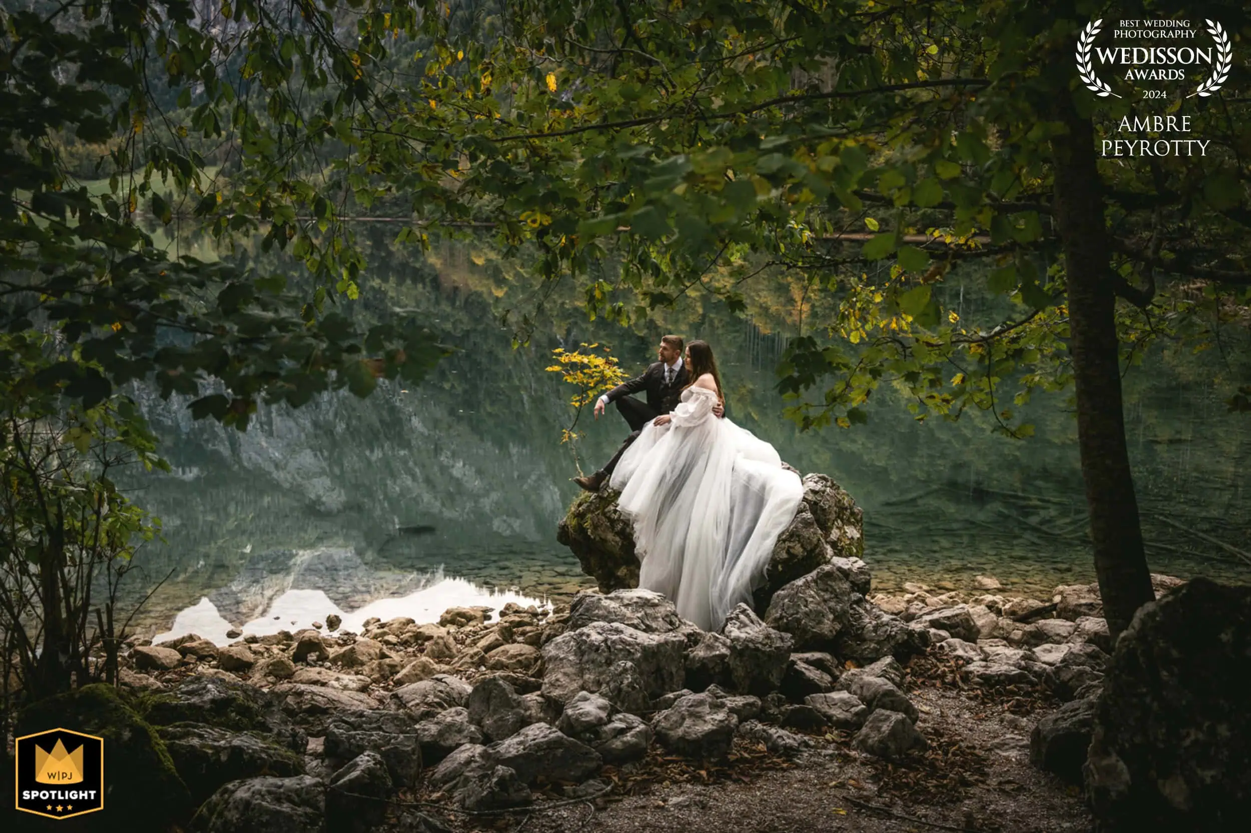 Elopement in nature with bride and groom on rocks by a river.