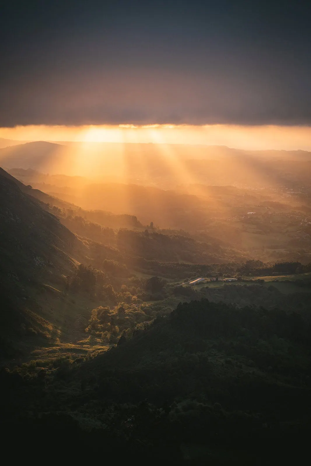 Dramatic shot of the sunset over a misty valley in an Asturias elopement