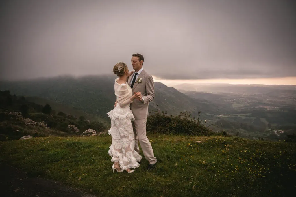 Couple sharing a quiet moment amidst green hills during their Asturias elopement