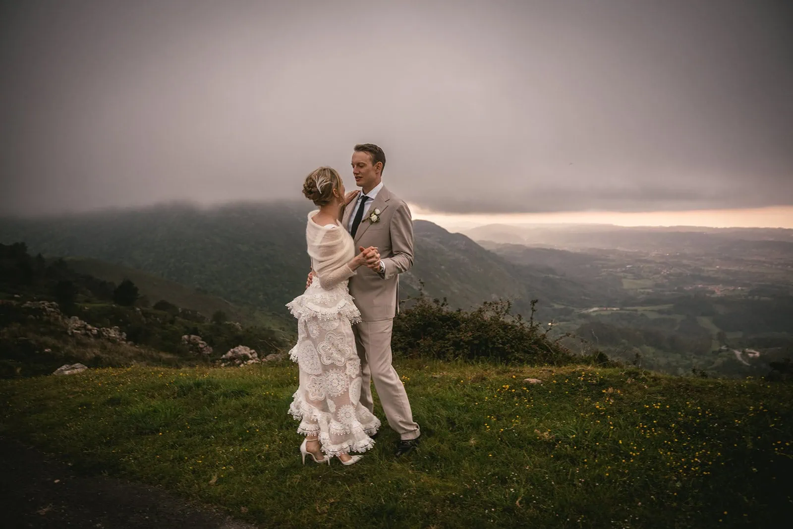 Couple sharing a quiet moment amidst green hills during their Asturias elopement