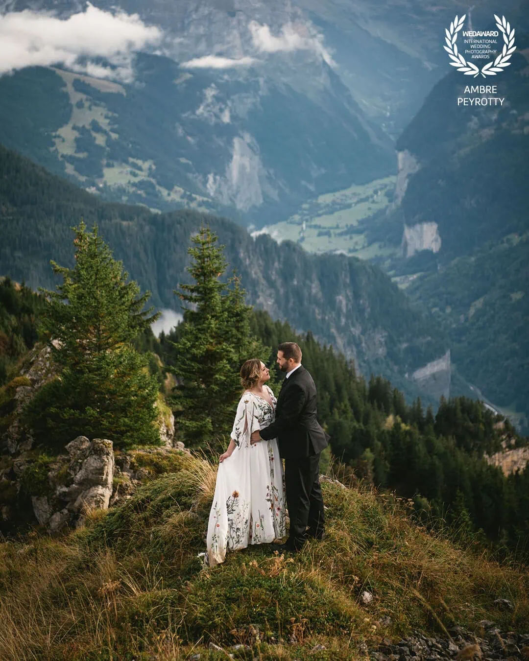 Couple sharing intimate moment in Japan's mystical blue mountains, showcasing the epic adventures included in our 7-day Interstellar Saga package
