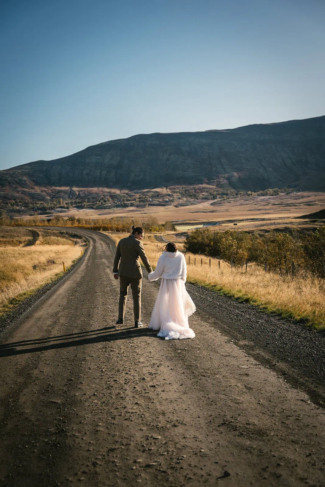 The couple walking along a scenic trail during their Reykjavik elopement adventure