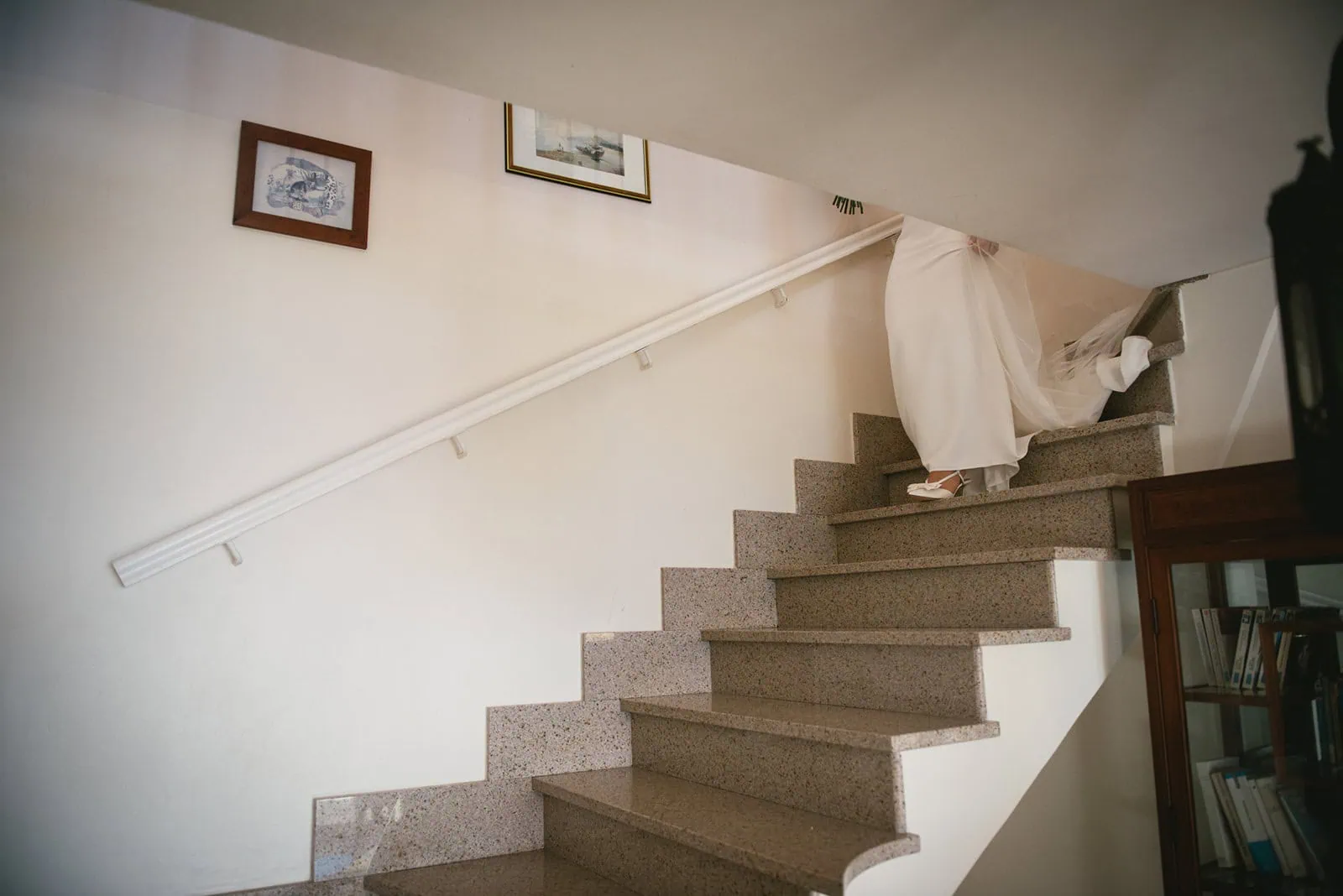 Bride going down the stairs for the first look of her South of France elopement