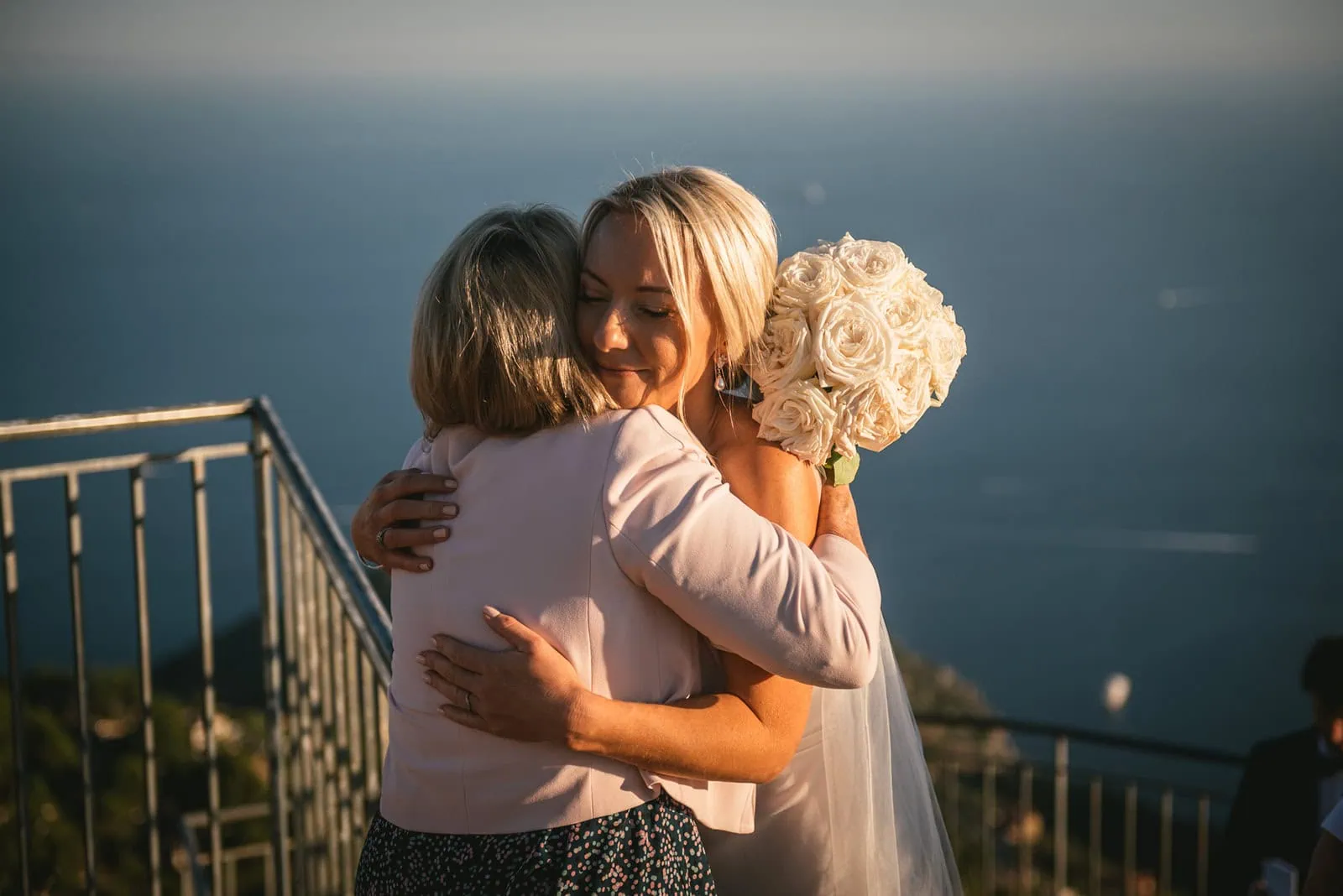 Bride sharing an embrace with her mother during her South of France elopement ceremony