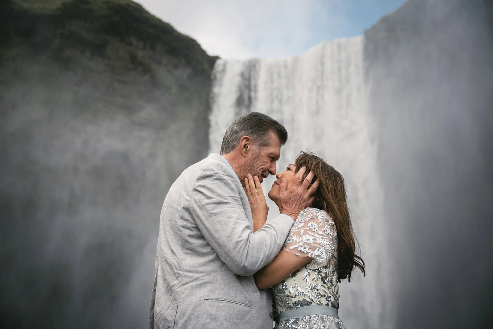 A perfect engagement moment as waterfall falls behind them